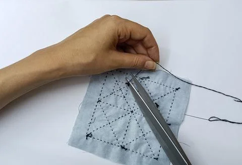 Hands stitching sashiko embroidery pattern on fabric Stock Photos