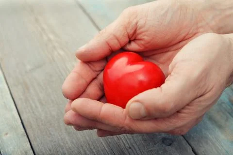 Hands with stone heart Stock Photos