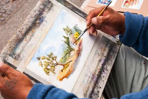 The hands of a street painter Stock Photos
