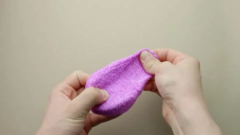 Hands stretching and molding squishy purple floam or glitter slime 動画素材 313097222