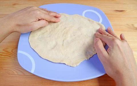 Hands stretching the dough for baking bread Stock Photos