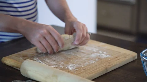 Hands stretching dough in Kitchen slow motion Stock Footage 93619744