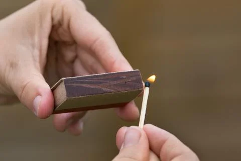 Hands striking a match Stock Photos
