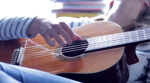 Hands on the strings of the guitar Stock Footage 53198801