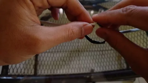 Hands stripping and twisting copper electrical wires together Stock Footage 332915904