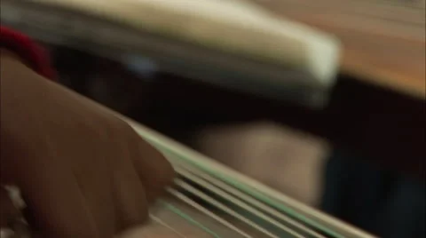 Hands strumming zither strings, music, China Stock Footage 56641507