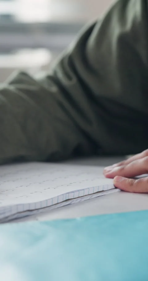 Hands, student and writing in class with book, maths answers and studying for Stock Footage 340946493