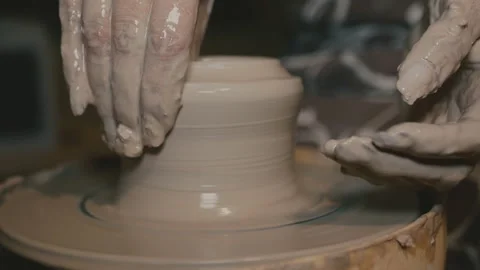 The hands of a student of a potter ineptly create dishes on a pottery wheel Stock Footage 118579759