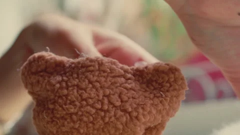 Hands Stuffing the Bear With Cotton at Build-A-Bear Workshop - Close Up Stock Footage 296279899