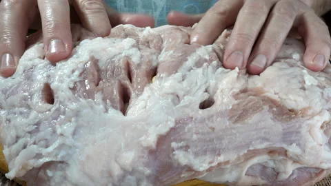 Hands stuffs raw meat with garlic in 4K Stock Footage 150721868
