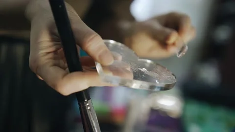 In the hands of a stylist, a tool for applying makeup. Shooting in close-up Stock Footage 171006298