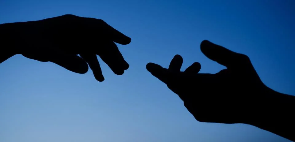 Hands support gesture silhouette. Giving helping hand. Care concept. Closeup. Stock Photos