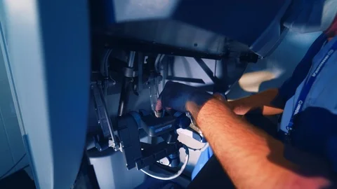 Hands of a surgeon at a computer robot. Medical robot. Robotic Surgery. Stock Footage 123515826