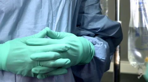 The hands of a surgical nurse exchange instruments with hands of a surgeon Stock Footage