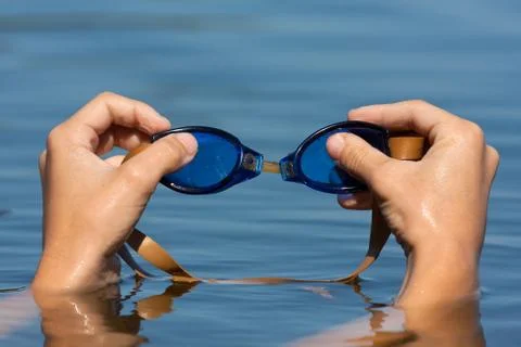 Hands with swimming goggles Stock Photos