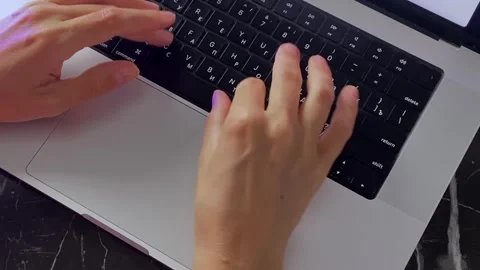 Hands swiping and typing on laptop, close-up top view Stock Footage 346743142