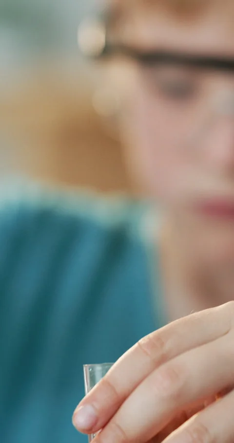 Hands, syringe and vial for homework with science for education, development and Vídeo Stock 336740416