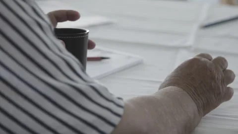 Hands at Table with Coffee Cup and Documents, Advisory Talk, Close Up Shot 動画素材 341518180