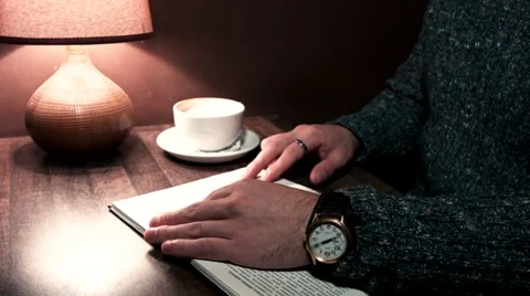 Hands on the table holding a book Video stock 56250772