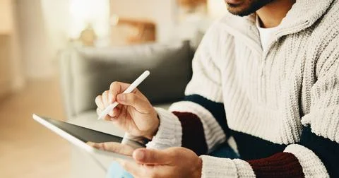 Hands, tablet and man with pen on sofa for remote work, web design and research Stock Photos