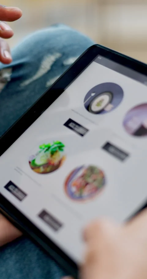 Hands, tablet and online shopping for fast food in home with screen, scroll or 動画素材 335787482
