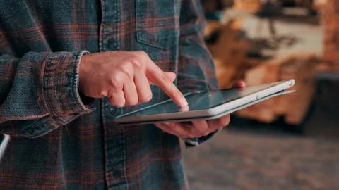Hands, tablet and scroll in carpentry workshop, check lumber order or onlin.. Stock-Fotos