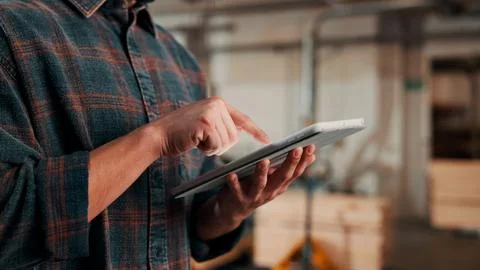 Hands, tablet and scroll in carpentry factory, check lumber order or online.. Stock-Fotos