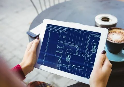 Hands with tablet with blueprint on it (two-tone: dark blue and light blue) Stock Photos