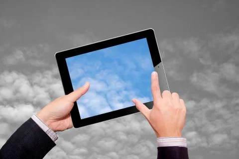 Hands with tablet computer. Isolated sky Stock Photos