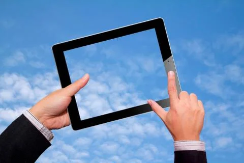 Hands with tablet computer. Isolated sky Stock Photos