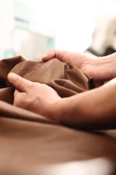 Hands tailor to check the quality of the material Stock Photos