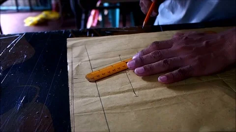 Hands of a tailor making a pattern of a dress Stock Footage 93344706