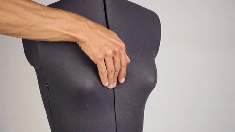 Hands tailor narrowing the size of breast on female sewing mannequin, side view Video stock 94364117