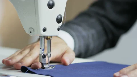 Hands of a Tailor Using a Sewing Machine Stock Footage 89575299