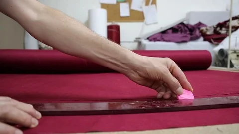 Hands of a tailor working in his shop, drawing template on fabric Stock Footage 84647287