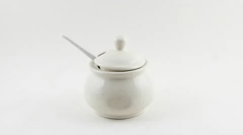 Hands take away and return a sugar pot and then take away a spoon full of sugar Stock Footage 68769818
