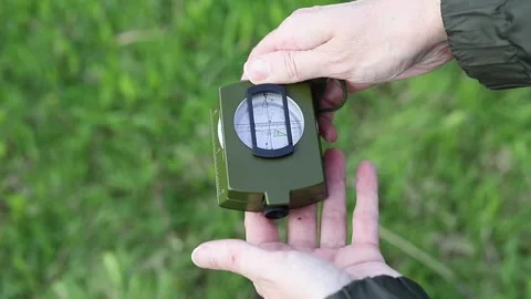 Hands take a compass out of its case and open the lid Stock Footage 338032486