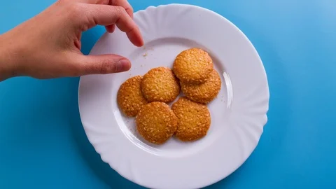 Hands take cookie from plate. Stock Footage 116772481