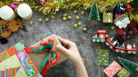 Hands take a gift box for Christmas present out of the shopping bag  on a table Stock Footage 166834834