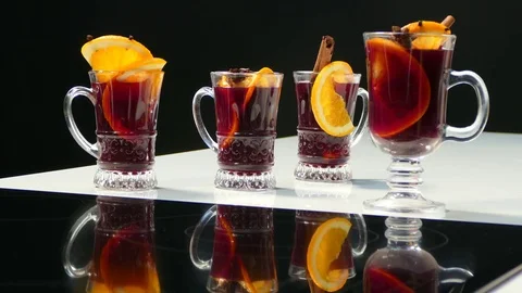 Hands take glasses with mulled wine and toast Stock Footage 78512975