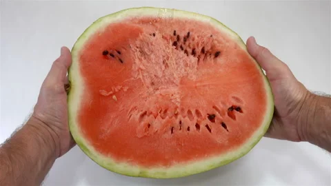 Hands take half a watermelon in 4K Stock Footage 139358394