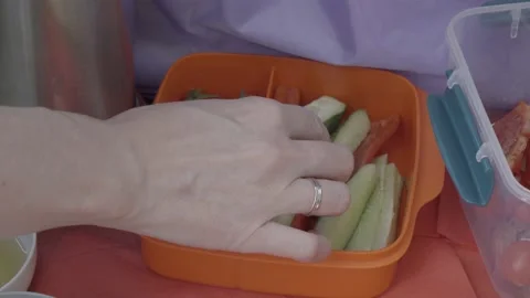 Hands take healthy vegetable snacks from the lunch box. Stock Footage 144891125