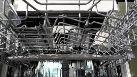 Hands take mugs from the upper dishwasher rack during unloading. Clean cups.. Stock Footage 337774039