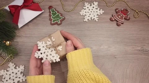 Hands take a packed Christmas gift, top view of a table with Christmas gifts and Stock Footage 294095371