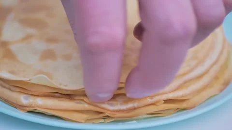 Hands take the pancakes on a plate close up Stock Footage 228714652