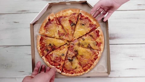 Hands take a slice of pizza top view. Pizza in a cardboard box. Eating, snack Stock Footage 168413042