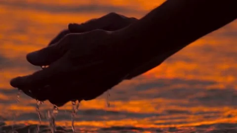 Hands take water at sunset Stock Footage 154191468