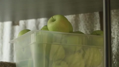 Hands taking clear crate of green apples off shelf Stock Footage 342818893
