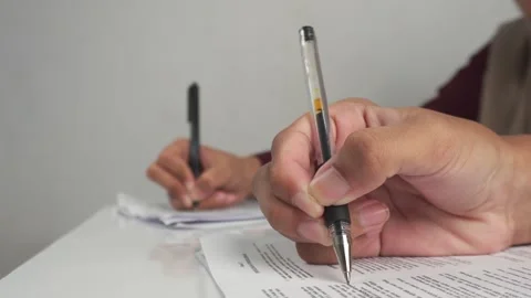 Hands taking exams in the classroom on table Stock Footage 277243134