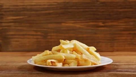 Hands taking french fries from a plate Video stock 82853053